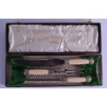 A CASED VICTORIAN/EDWARDIAN CARVED IVORY AND STEEL SET OF SERVING UTENSILS.