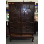 AN ANTIUE GLAZED DISPLAY CABINET.