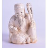 A LATE 19TH CENTURY CHINESE CARVED IVORY FIGURE OF A SEATED SCHOLAR modelled holding a vessel and