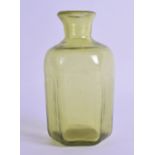 AN ANTIQUE YELLOWISH GREEN GLASS BOTTLE. 14.5 cm high.