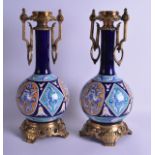 A PAIR OF LATE 19TH CENTURY CONTINENTAL TWIN HANDLED VASES with French bronze mounts, painted with