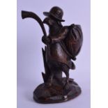 A 19TH CENTURY BAVARIAN BLACK FOREST FIGURE OF A HOUND modelled holding a pipe. 23 cm high.