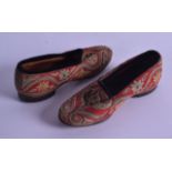 A PAIR OF 19TH CENTURY CONTINENTAL EMBROIDERED SHOES decorated with flowers. 17 cm long.