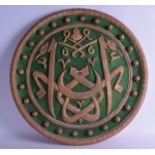 A LARGE ISLAMIC POLYCHROMED WOODEN CALLIGRAPHY PANEL decorated with gilt roundels. 64 cm diameter.