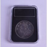 A CHINESE SILVER ONE DOLLAR COIN. 26.8 grams.