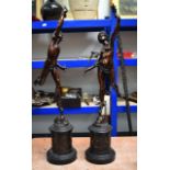 A LARGE PAIR OF 19TH CENTURY EUROPEAN BRONZE FIGURES OF A CLASSICAL MALE AND FEMALE supported upon