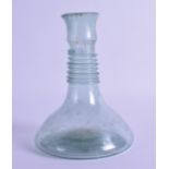 A ROMAN CLEAR GLASS BOTTLE with ribbed decoration. 15.5 cm high.