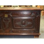 A LOVELY EARLY 18TH CENTURY FRENCH CARVED OAK COFFER decorated with floral panels. 146 cm x 65 cm.