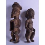 A PAIR OF EARLY 20TH CENTURY AFRICAN CARVED HARDWOOD FERTILITY FIGURES. 32 cm high.