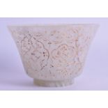AN ISLAMIC CARVED WHITE JADE CUP engraved and gilded with scrolling foliage. 8.5 cm diameter.