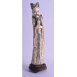 A 19TH CENTURY CHINESE CARVED IVORY FIGURE OF AN IMMORTAL modelled in floral engraved robes. 746