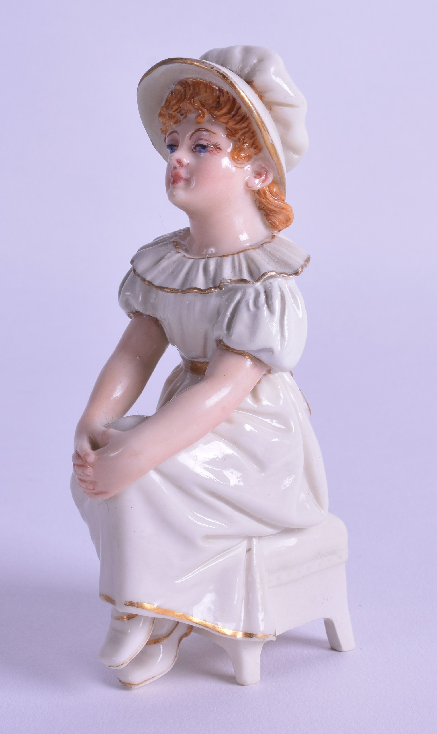 Royal Worcester uncommon Kate Greenaway figure of a girl seated on a stool with her hands in her