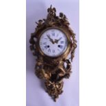 A MID 19TH CENTURY FRENCH GILT BRONZE CARTEL CLOCK with white enamel dial, the case mounted with