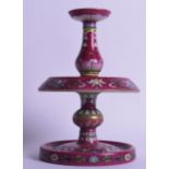 AN UNUSUAL CHINESE FAMILLE ROSE RUBY GROUND PORCELAIN ALTAR STICK bearing Qianlong marks to base,