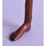 AN ANTIQUE CARVED WOOD 'FOOT' WALKING CANE. 84 cm long.