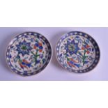 A PAIR OF TURKISH OTTOMAN OR IZNIK STYLE DISHES painted with flowers. 13.5 cm diameter.