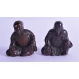 A PAIR OF 19TH CENTURY JAPANESE MEIJI PERIOD BRONZED LEAD FIGURES modelled seated in engraved robes.