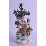 A 19TH CENTURY MEISSEN PORCELAIN FIGURE OF A KNIFE GRINDER modelled beside a putti, upon a