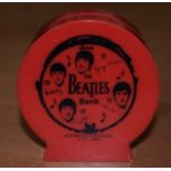 A VINTAGE BEATLES MONEY BOX.