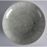 A Fine Safavid pale glazed saucerdish, 17th Century, Persian, incised with motifs. 9Ins diameter.