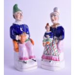 A RARE PAIR OF 19TH CENTURY STAFFORDSHIRE FIGURES OF PUNCH & JUDY modelled seated. 23 cm high.