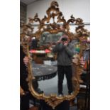 A SCROLLING GILTWOOD MIRROR Louis XV style. 76 cm x 126 cm.