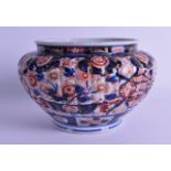 AN EARLY 19TH CENTURY JAPANESE EDO PERIOD IMARI SCALLOPED BOWL painted with buildings and iron red