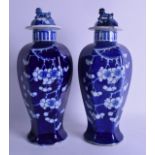 A PAIR OF CHINESE BLUE AND WHITE HEXAGONAL VASES AND COVERS decorated with flowers. 34 cm high.