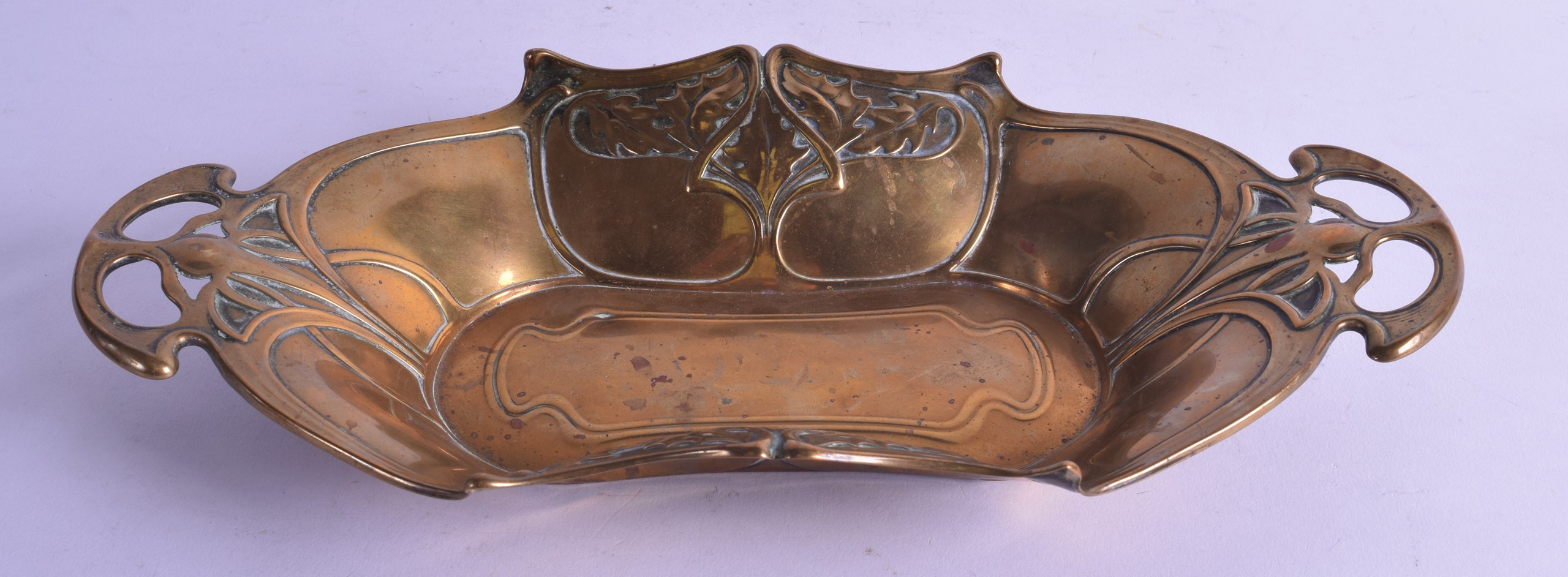 AN ART NOUVEAU TWIN HANDLED WMF BRASS DISH decorated with stylised foliage. 30 cm wide.