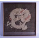 A 19TH CENTURY CHINESE FRAMED KESI TYPE EMBROIDERED PANEL depicting a dragon upon a brown ground. 46