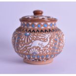 A STYLISH ENAMELLED POTTERY JAR AND COVER decorated in the deco style with animals and motifs. .