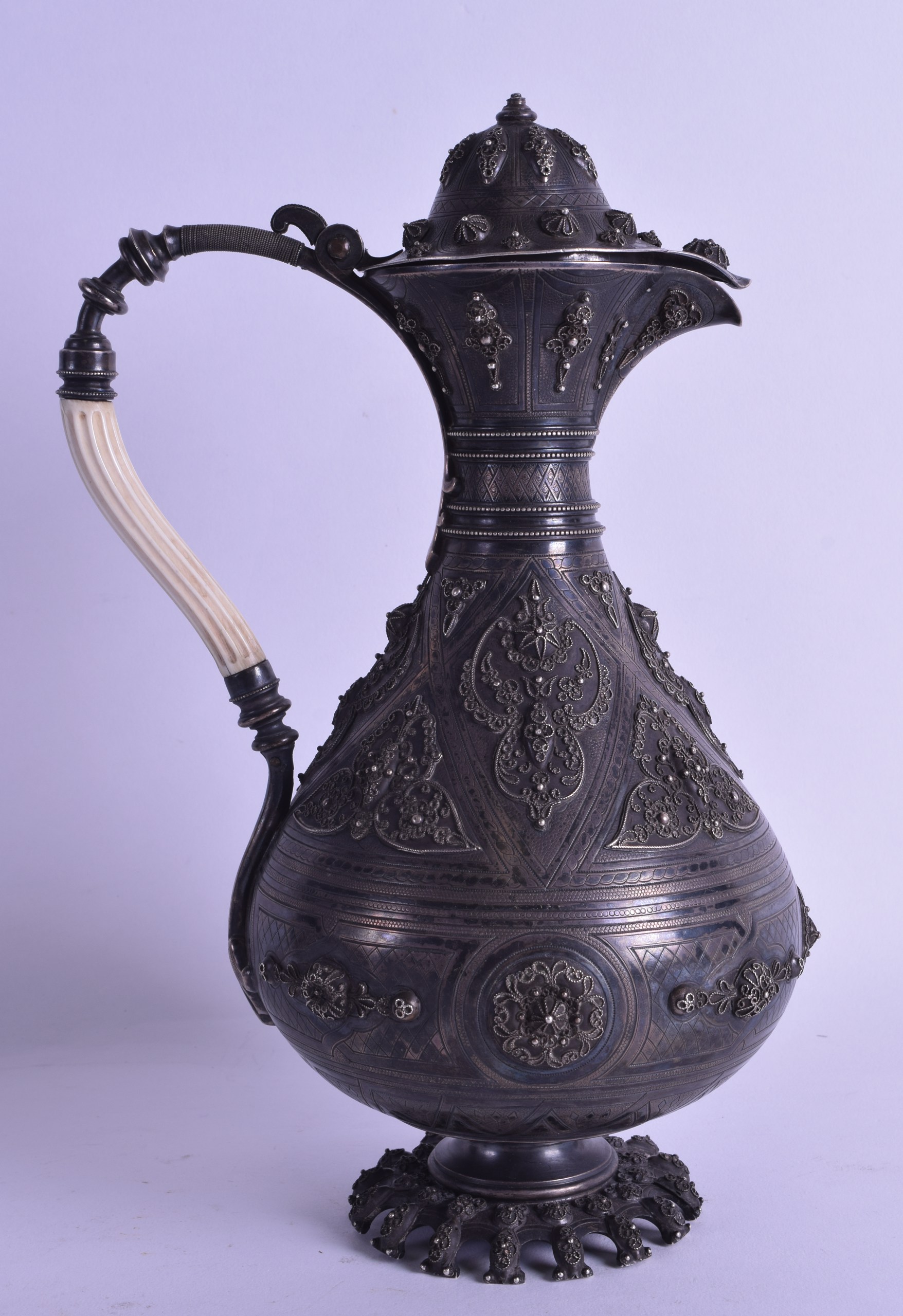 A FINE 18TH/19TH CENTURY PERSIAN/OTTOMAN SILVER EWER with scrolling ivory handle, decorated with