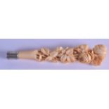 A 19TH CENTURY CARVED EUROPEAN CARVED IVORY PARASOL HANDLE of naturalistic form, carved all over