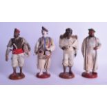 A SET OF FOUR 19TH CENTURY INDIAN PUNA FIGURES OF TRADESMAN modelled upon circular bases. 21 cm