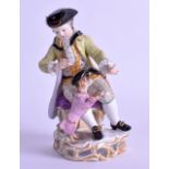 A 19TH CENTURY MEISSEN PORCELAIN FIGURE OF A YOUNG BOY modelled training a begging hound, upon a