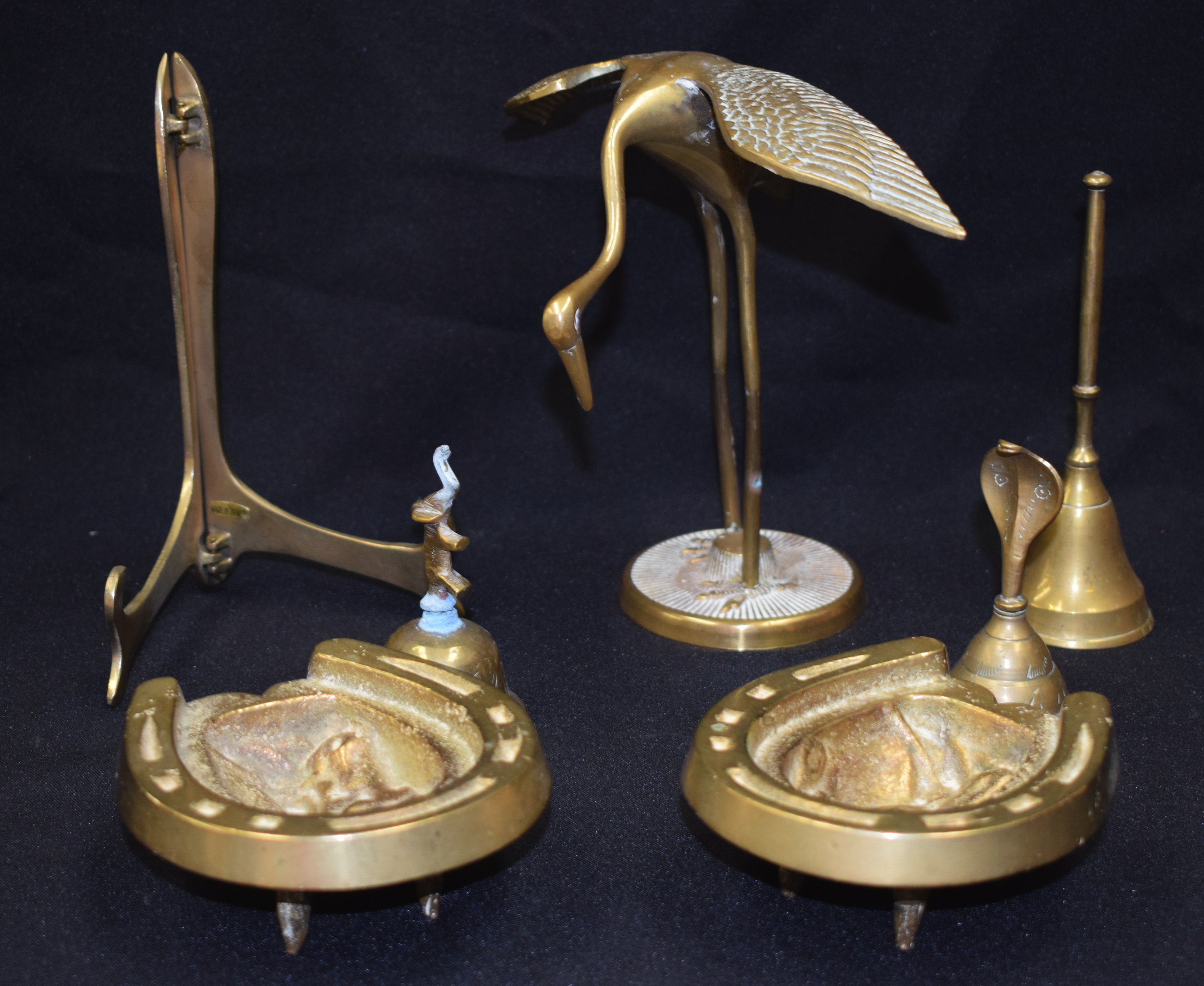 A GROUP OF BRASS ARTICLES, including a stork, bell, picture stand etc. (7)