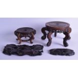 FOUR EARLY 20TH CENTURY ORIENTAL CARVED HARDWOOD STANDS in various forms and sizes. Largest 27 cm