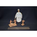 A CHINESE WOODEN DOLL, together with two other figures an a pair of sticks with foo dog terminal.(