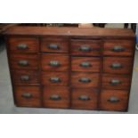 AN ANTIQUE MAHOGANY HABERDASHERY CABINET, sixteen drawers and shell type iron fitted handles. 65