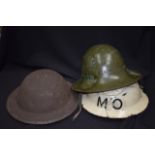 A GROUP OF TEN MILITARY HELMETS, of varying style. (10)