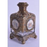 A LATE 19TH CENTURY EUROPEAN BRASS OVERLAID GRAND TOUR SCENT BOTTLE inset with five miniatures