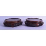 A LARGE PAIR OF 19TH CENTURY CHINESE CARVED HARDWOOD STANDS with pierced foliate frieze. 19 cm