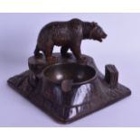 A LATE 19TH CENTURY BAVARIAN BLACK FOREST SMOKERS COMPENDIUM modelled with a roaming bear. 18 cm