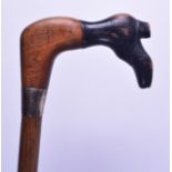 A RARE 19TH CENTURY CARVED WOOD WALKING CANE with silver mounts, with shoe terminal. 90 cm long.