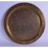 A 19TH CENTURY PERSIAN SILVER INLAID MIXED METAL AND BRASS CIRCULAR DISH decorated with scrolling