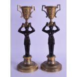 A PAIR OF EARLY 19TH CENTURY FRENCH CANDLESTICKS with reversible sconces, formed as standing