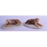 A PAIR OF LATE 19TH/20TH CENTURY EUROPEAN ALABASTER FIGURES OF HOUNDS modelled upon oval bases. 14