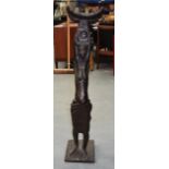 A GOOD LARGE CAST BRONZE FIGURE OF AN AFRICAN FEMALE by Saka Acquaye, modelled holding aloft a