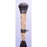 A VICTORIAN CARVED IVORY AND SILVER MOUNTED LADIES PARASOL with knobbled handle. 83 cm long,