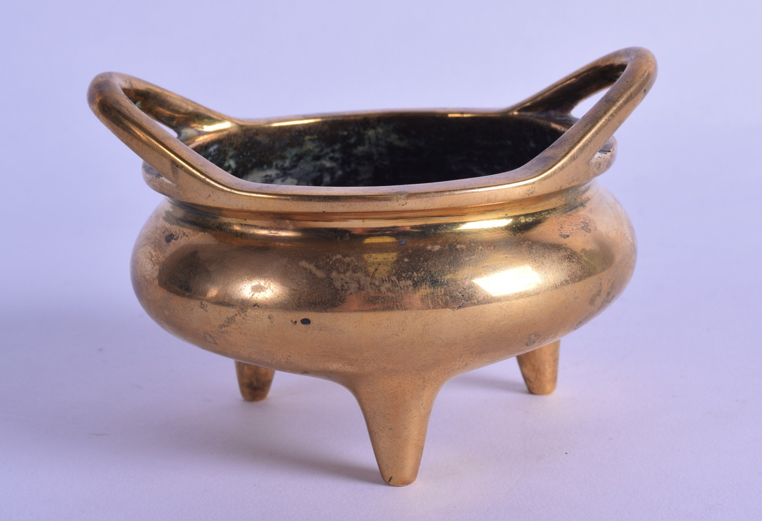 AN 18TH/19TH CENTURY CHINESE TWIN HANDLED BRONZE CENSER bearing Xuande marks to base, with high loop